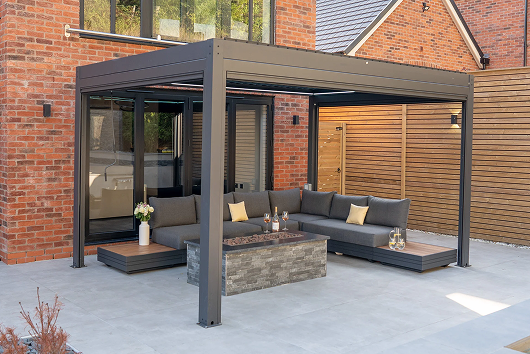 Modern patio with pergola, sectional seating, and fire table.