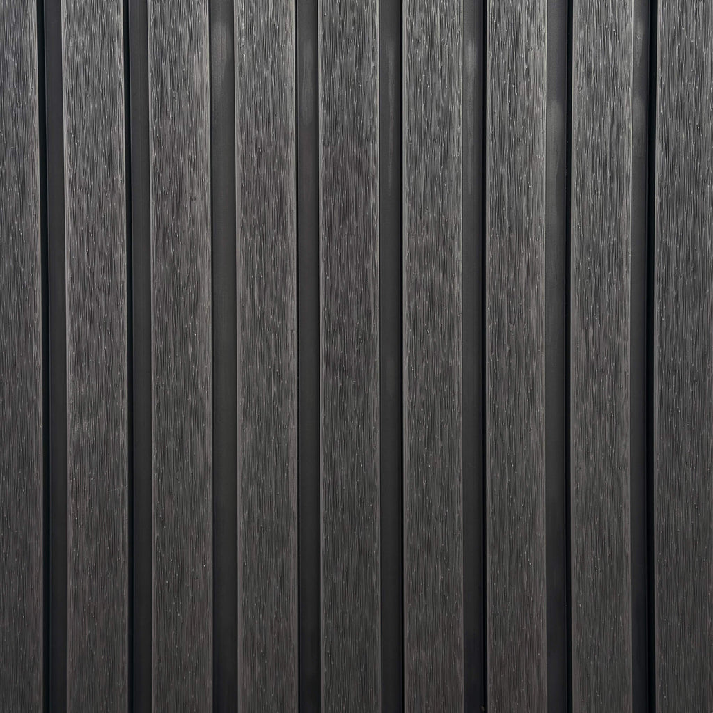 Close-up of charcoal outdoor vertical slat wall with a textured grain finish.