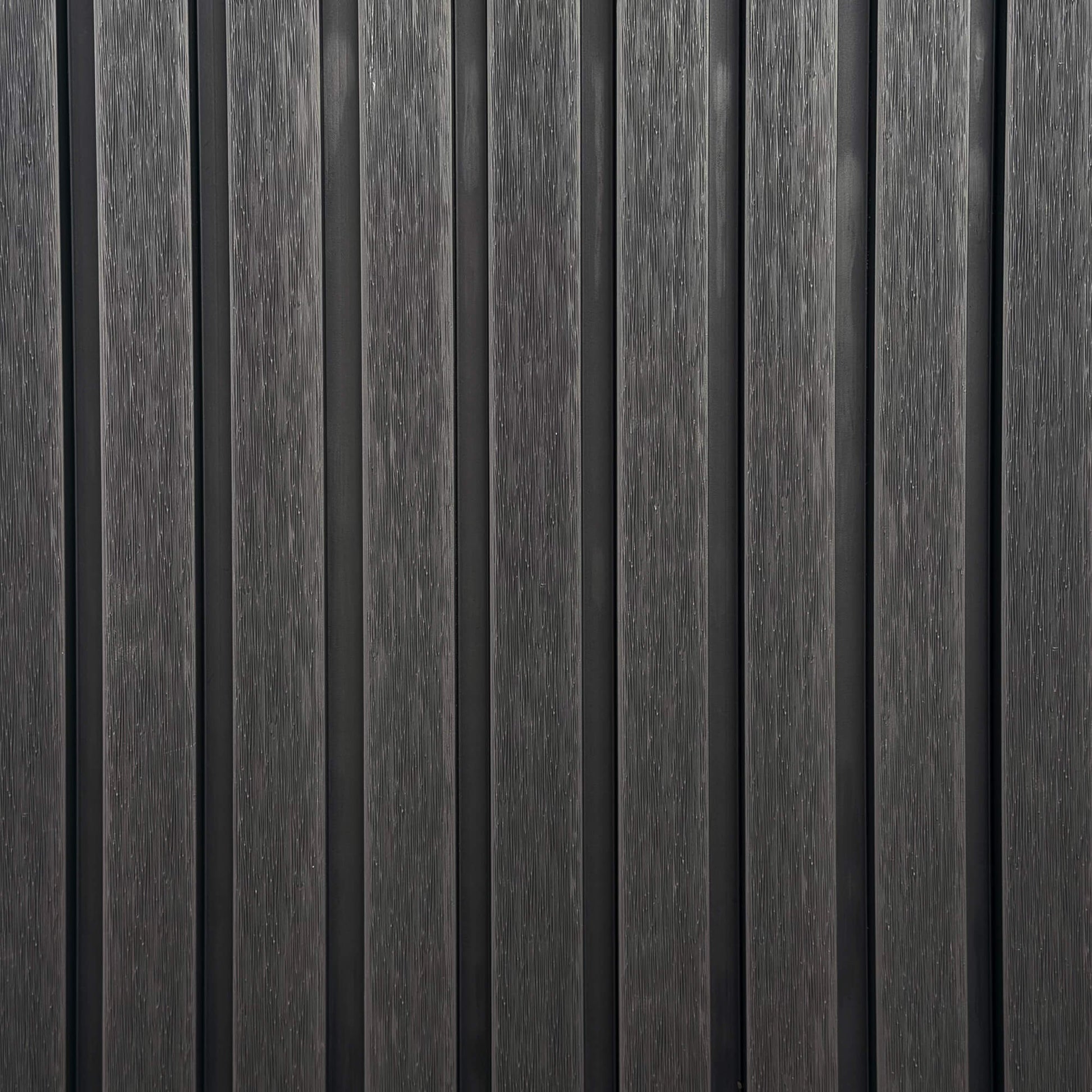 Close-up of charcoal outdoor vertical slat wall with a textured grain finish.