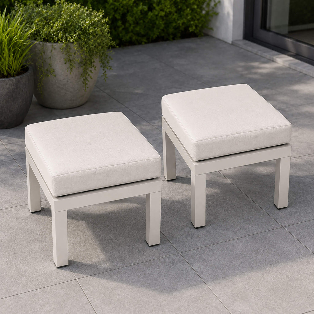 Como foot stool set with cushioned seats on a tiled patio with potted plants in the background.